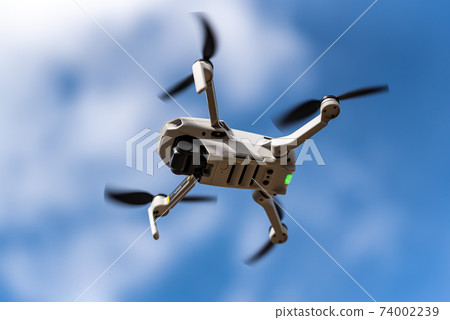 Unmanned drone flying in the sky Unmanned drone flying in the sky 74002239