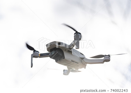 Unmanned drone flying in the sky Unmanned drone flying in the sky 74002243