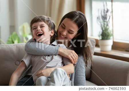 Happy young mom play with smiling small child 74002393
