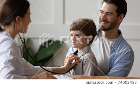 Female doctor listen to child patient heart 74002458