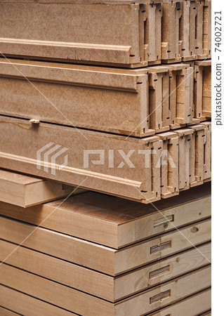 Joinery. Wood door manufacturing process. Stacked door leafs and architraves. Furniture manufacture 74002721
