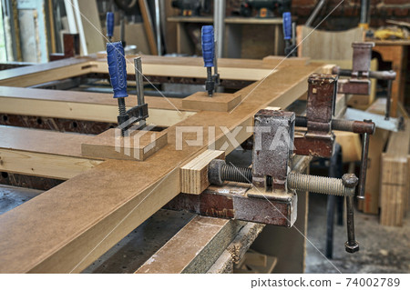 Joinery. Wood door manufacturing process. Clamping and gluing door leaf. Furniture manufacture 74002789