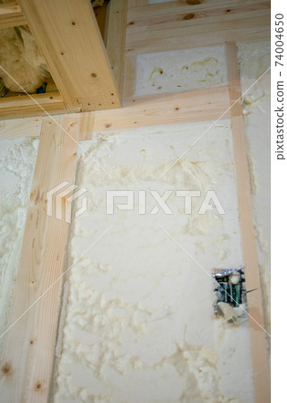 Construction site of a newly built single-family house with spray insulation Construction site of a newly built single-family house with spray insulation 74004650