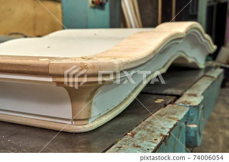 Classic wardrobe crown molding. Production of wood furniture. Furniture manufacture. Close-up 74006054
