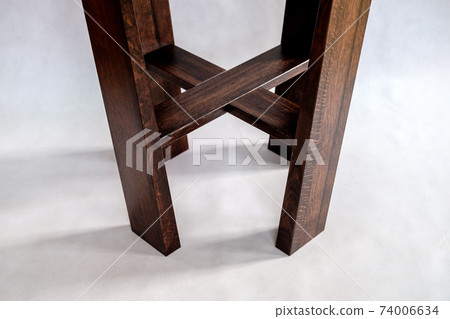 Wooden coffee table with acrylic table top on white background. Close-up 74006634