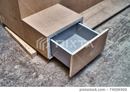 Nightstand building process. Nightstand with open drawer. Wooden furniture manufacturing process. Furniture manufacture Nightstand building process. Nightstand with open drawer. Wooden furniture manufacturing process. Furniture manufacture 74006908