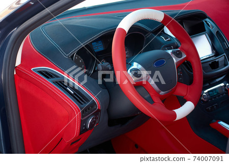 Car dashboard. Car interior details. Red and black alcantara with stitching 74007091