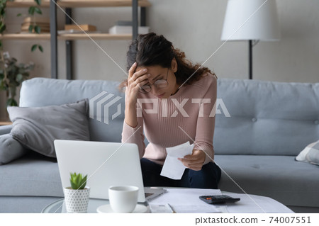 Unhappy young woman feeling stressed of lack of money. Unhappy young woman feeling stressed of lack of money. 74007551