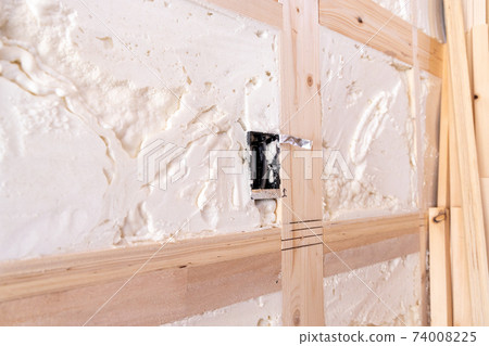 Walls and outlets at the construction site of a newly built single-family home with spray insulation 74008225