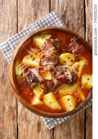 Bonava is a traditional lamb and potatoes stew from Mauritania closeup in a bowl. Vertical top view Bonava is a traditional lamb and potatoes stew from Mauritania closeup in a bowl. Vertical top view 74008250