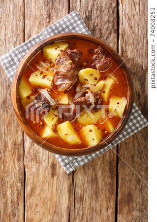 Mauritanian cuisine Bonava is a traditional lamb stew and potatoes close-up in a bowl. Vertical top view 74008251