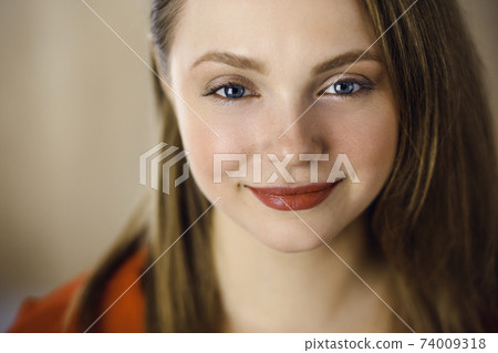 Head shot of a smart confident smiling millennial european woman standing with folded arms at home. Attractive young teenager student girl freelancer looking at camera, dressed in red Head shot of a smart confident smiling millennial european woman standing with folded arms at home. Attractive young teenager student girl freelancer looking at camera, dressed in red 74009318