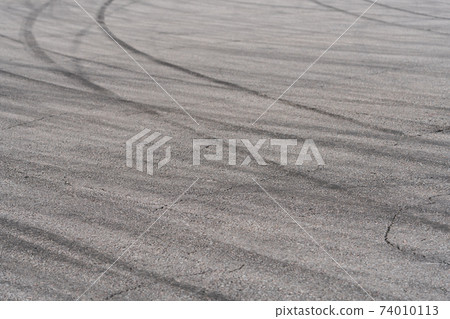 Asphalt with black rubber marks from tyres Asphalt with black rubber marks from tyres 74010113