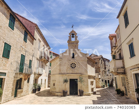 Small church on square of small urban village of Stari grad on Hvar island in Croatia, Adriatic Sea, Europe. 74010365