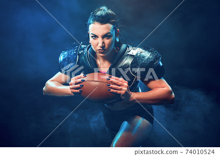 Sportive woman with rugby ball 74010524