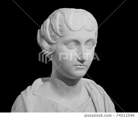 Ancient white marble sculpture bust of Faustina the Younger. Wife of Roman Emperor Marcus Aurelius. Statue of young woman isolated on black 74011046