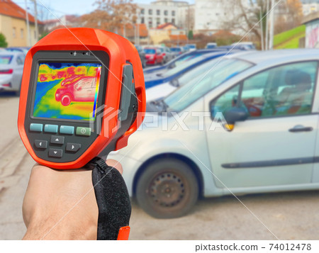 Recording with thermal camera showing parked cars at town parking a lot of Recording with thermal camera showing parked cars at town parking a lot of 74012478