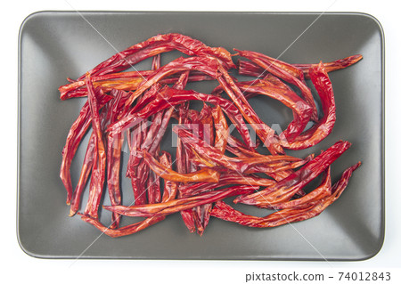 red dried hot peppers on a gray background. vitamin food red dried hot peppers on a gray background. vitamin food 74012843