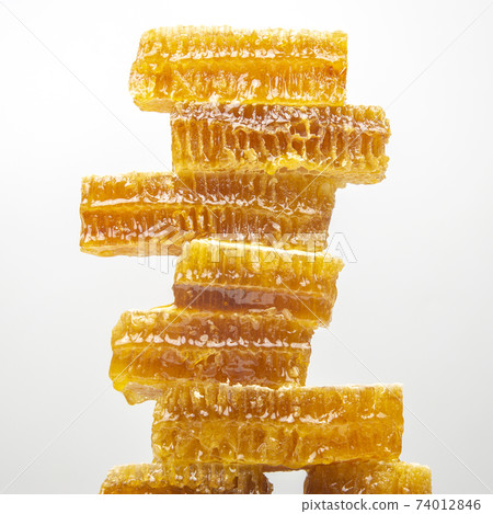 portions of fresh honeycomb on a white background. vitamin natural food. bee work product portions of fresh honeycomb on a white background. vitamin natural food. bee work product 74012846