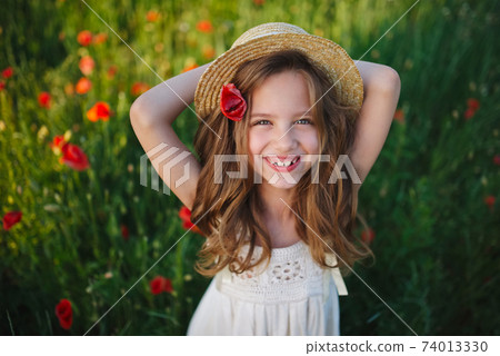 cute little girl in meadow with red poppies cute little girl in meadow with red poppies 74013330
