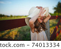 little girl in linen dress in countryside 74013334