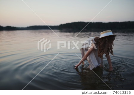 little cute girl with long hair on the lake little cute girl with long hair on the lake 74013336