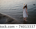little cute girl with long hair on the lake 74013337