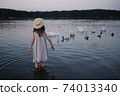 little cute girl with long hair on the lake 74013340