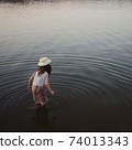 little cute girl with long hair on the lake 74013343