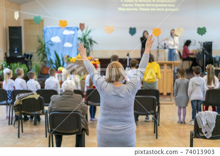 People praying in a church. soft focus of christian people group raise hands up worship God Jesus Christ together in church People praying in a church. soft focus of christian people group raise hands up worship God Jesus Christ together in church 74013903