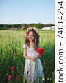 cute little girl in meadow with red poppies 74014254