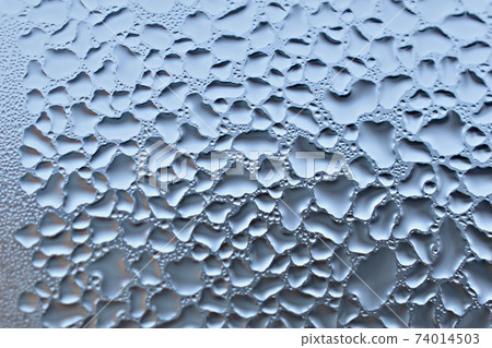 Textured pattern of condensation on the glass of the window frame. 74014503