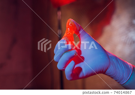 Liquid sugar for skin epilation rubber gloves close-up. Liquid sugar for skin epilation rubber gloves close-up. 74014867