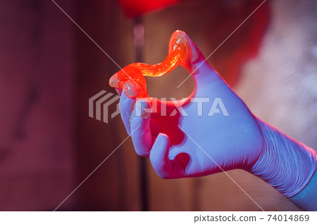 Liquid sugar for skin epilation rubber gloves close-up. Liquid sugar for skin epilation rubber gloves close-up. 74014869
