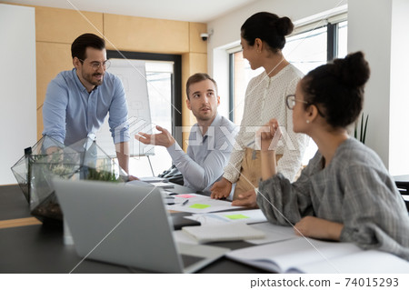 Diverse business team discussing project at corporate briefing Diverse business team discussing project at corporate briefing 74015293