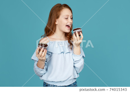child girl holding in hands delicious cupcakes child girl holding in hands delicious cupcakes 74015343