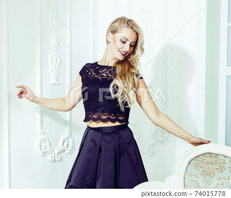 pretty blond woman in rich luxury house interior, fashion people pretty blond woman in rich luxury house interior, fashion people 74015778
