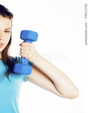 young pretty slim woman with dumbbell isolated on white background, cheerful smiling 74015782