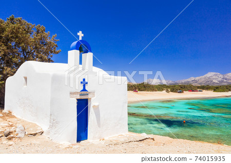 Traditional authentic Greece. Beautiful beach and small church in Naxos island Traditional authentic Greece. Beautiful beach and small church in Naxos island 74015935