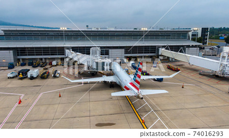 Aerial view of regional airport with terminal and airplanes Aerial view of regional airport with terminal and airplanes 74016293