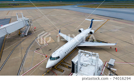 Aerial view of regional airport with terminal and airplanes 74016294