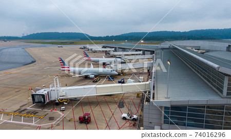 Aerial view of regional airport with terminal and airplanes Aerial view of regional airport with terminal and airplanes 74016296