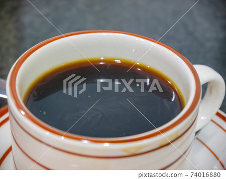 Close up shot of a cup of hot coffee Close up shot of a cup of hot coffee 74016880