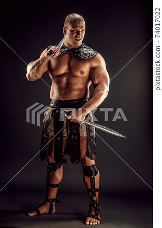 Severe barbarian in leather costume with sword Severe barbarian in leather costume with sword 74017022