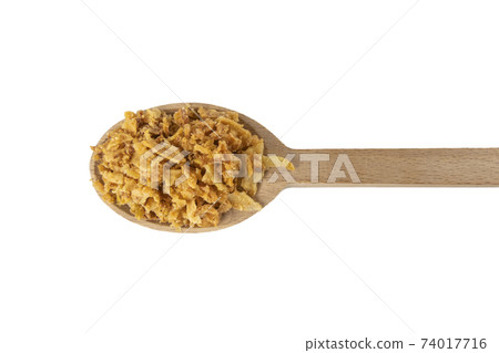 Crispy carmelized fried onion flakes in wooden spoon isolated on white background. Spices and food ingredients. 74017716