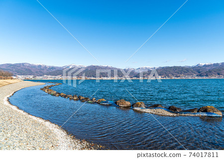 "Nagano Prefecture" A distant snowy mountain seen over Lake Suwa 74017811