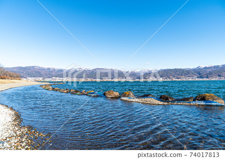"Nagano Prefecture" A distant snowy mountain seen over Lake Suwa "Nagano Prefecture" A distant snowy mountain seen over Lake Suwa 74017813