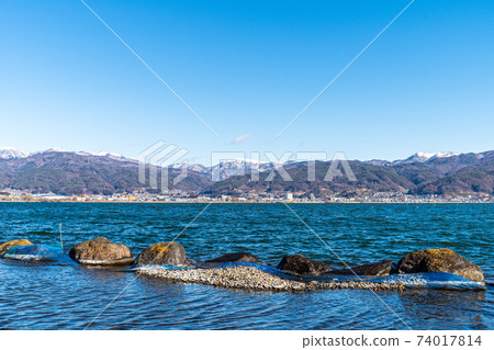 "Nagano Prefecture" A distant snowy mountain seen over Lake Suwa "Nagano Prefecture" A distant snowy mountain seen over Lake Suwa 74017814