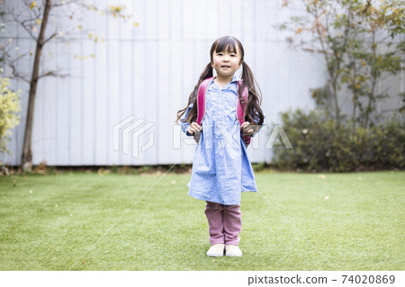 New first grader carrying a parcel New first grader carrying a parcel 74020869