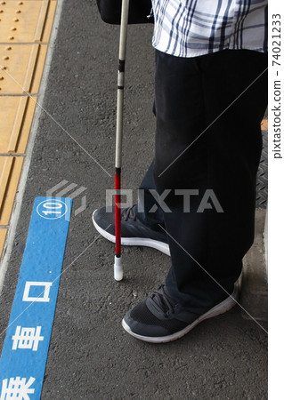 Visually disabled people waiting for the train at the station 74021233